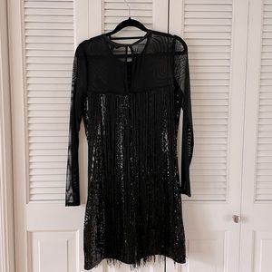 Black sequin and fringe mini dress with sexy mesh sleeves and eyelet back detail